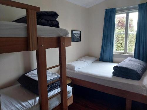 two bunk beds in a room with a window at Station Lodge in Ohakune