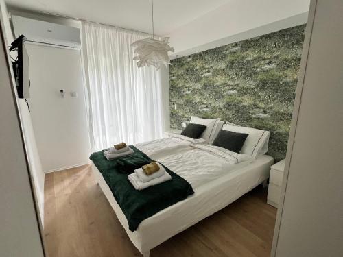 a bedroom with a bed with two towels on it at Ljubičica in Čačak