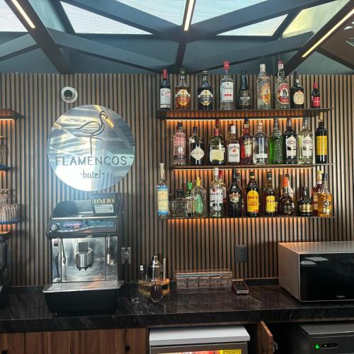 a bar with a lot of bottles of alcohol on the wall at Hotel Flamencos Centro Histórico in Mexico City