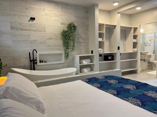 a bedroom with a large bed and a room with at Pousada Camburioca in Camburi