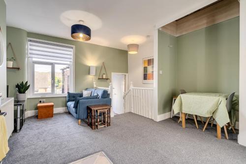 a living room with a couch and a table at The Old Bike Shop Flat 2 in Heapey