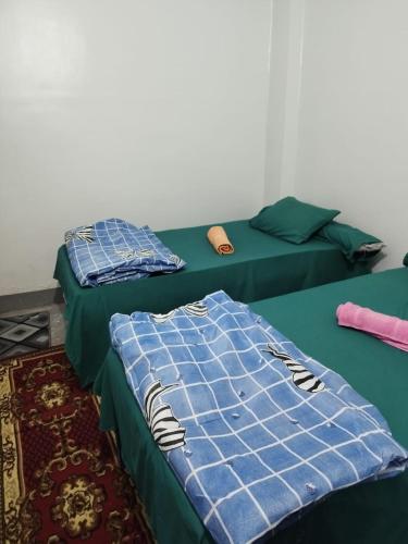 two beds sitting next to each other in a room at Grand Square Hostel Luxor in Luxor