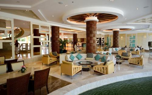 a lobby of a hotel with couches and chairs at Henann Resort Alona Beach in Panglao