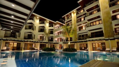 a swimming pool in the middle of a building at Henann Resort Alona Beach in Panglao