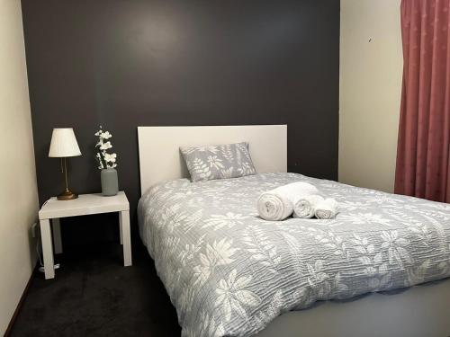 a bedroom with a bed with two towels on it at Holiday Home in Drouin in Drouin