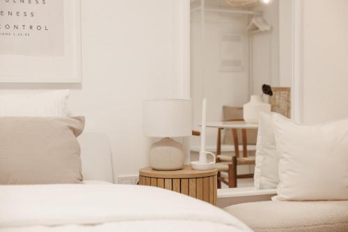 a bedroom with a bed and a table with a lamp at BOHO Loft - Augarten City Apartment, Terrace in Vienna