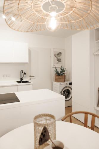 a kitchen with a white counter and a ceiling at BOHO Loft - Augarten City Apartment, Terrace in Vienna