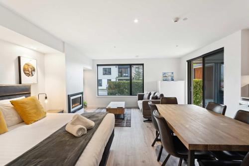 a living room with a couch and a table at Rēhia at La residence du Parc in Queenstown