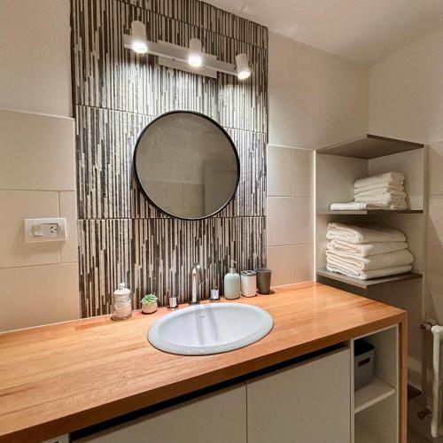 a bathroom with a sink and a mirror at Aiila House in Esquel