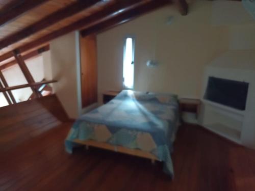 a bedroom with a bed in a room with a window at Champ Cervi in San Antonio de Arredondo