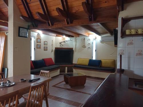 a living room with couches and a table and a television at Champ Cervi in San Antonio de Arredondo