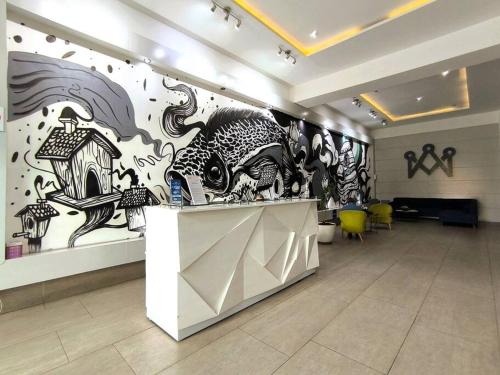 a room with a wall with paintings on it at 412 Apartamento completo Zona 1 Con estacionamiento in Las Victorias
