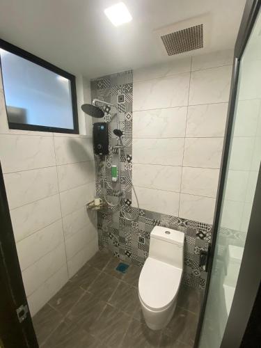 a bathroom with a toilet and a shower at ParkCity Inn in Sibu