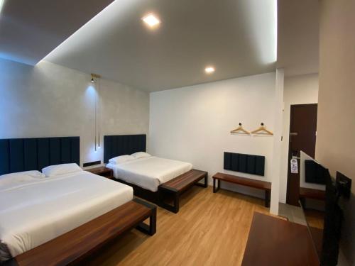 a hotel room with two beds and a table at ParkCity Inn in Sibu