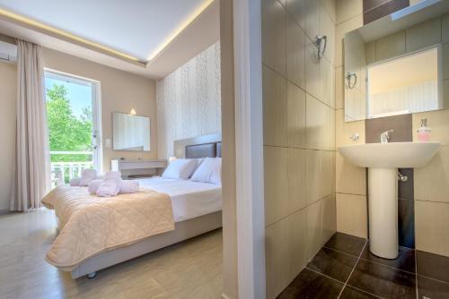 a hotel room with a bed and a sink at Nastazia Studios in Laganas