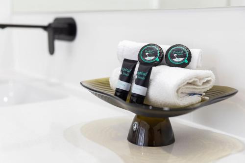 a towel rack with towels on it in a bathroom at Shoreline Luxe - Refined Beachside Elegance with Spa in Caves Beach