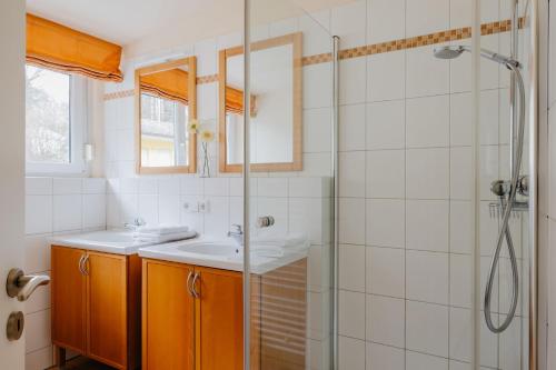 a bathroom with a sink and a shower at Ferienhaus Hilde in Meersburg