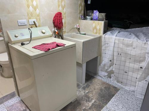 a bathroom with a sink and a toilet at Olimpo Estadía IBAGUÉ in Ibagué