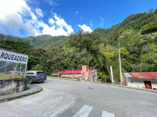 a car parked on the side of a road at Olimpo Estadía IBAGUÉ in Ibagué