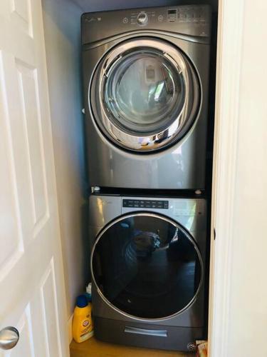 a washing machine and a dryer in a room at Golden Hour Villa in Peggy's Cove Rd in French Village