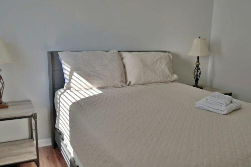 a bedroom with a large white bed with two pillows at Summer Bookings Available NOW! Going Fast! in Calabash