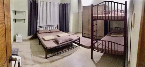 a bedroom with two bunk beds in a room at JD Homestays CDO in Cagayan de Oro