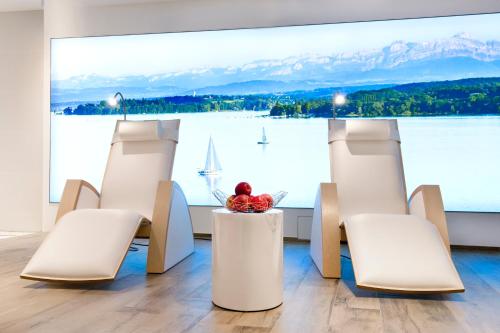 a person sitting on a table in front of a large window at Gästehaus Holzer in Konstanz