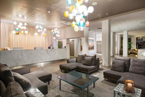 a lobby with couches and a bar in a building at Clarion Hotel Admiral in Bergen