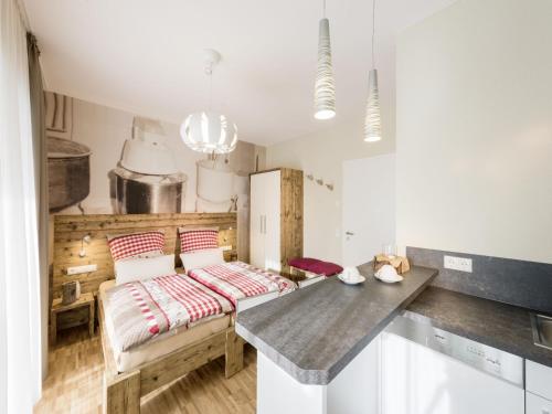 a room with a bed and a table in it at Webers "alte Backstube" in Friedrichshafen