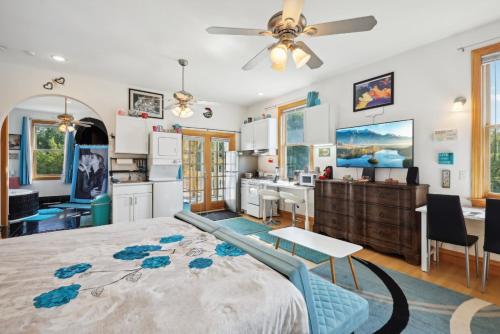 a bedroom with a large bed and a kitchen at The Starlight Tower Hot Tub Suite with 8-Jet Massage Shower and Amazing Views in Fort Atkinson