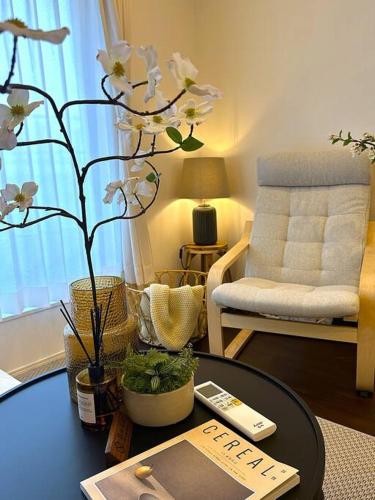 a living room with a coffee table with a book at Osaka KyoSai-A 栖晚 in Osaka