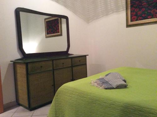 a mirror sitting on top of a dresser with a bed at Favignana Vacanze in Favignana