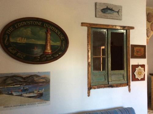 a picture of a window and a picture of a lighthouse at Favignana Vacanze in Favignana