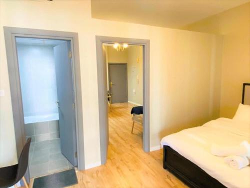 a bedroom with a bed and a door leading to a hallway at Royal Manor- Marina Diamond 2 in Dubai