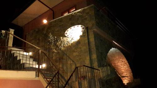 a clock on the side of a building at night at Affittacamere Elisabetta in Vernazza