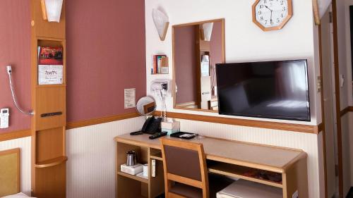 a room with a desk with a tv and a mirror at Toyoko Inn Fukushima-eki Higashi-guchi No 2 in Fukushima
