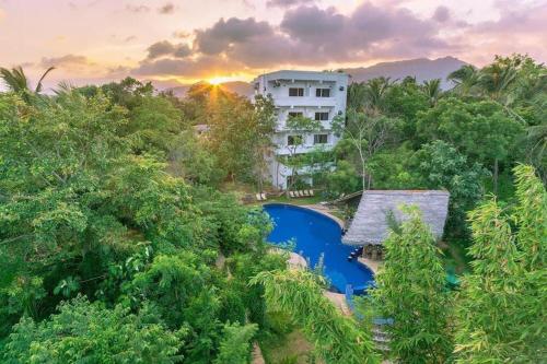 an aerial view of a resort with a pool and trees at Sundaras Resort LTD in Dambulla