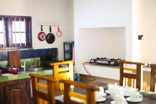 a kitchen with a stove and a table with chairs at Coastal House in Mirissa