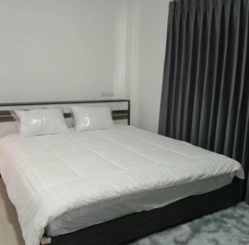 Ένα ή περισσότερα κρεβάτια σε δωμάτιο στο PLUEMCHAI Home