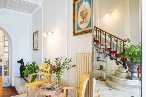 a living room with a table and a staircase at Grande Albergo Quattro Stagioni in Rieti