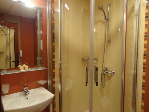 a bathroom with a shower and a sink at Favorit Hotel in Sofia