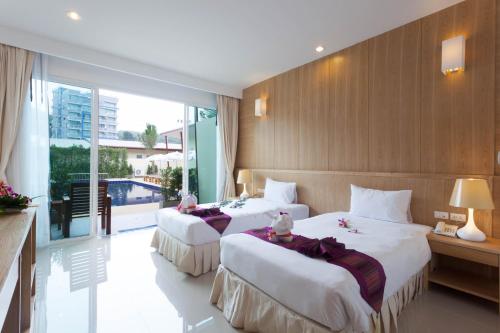 Krevet ili kreveti u jedinici u okviru objekta Chalong Princess Pool Villa Resort SHA EXTRA PLUS