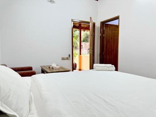 a white bed in a room with a window at Angel Eco Resort, Cox Bazar in Dhoāpālong