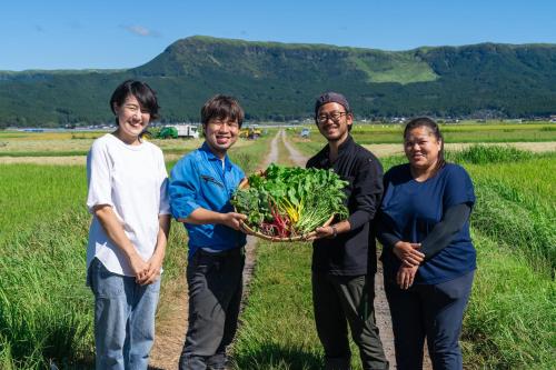 a group of people holding a basket of vegetables at KAMENOI HOTEL Aso in Aso