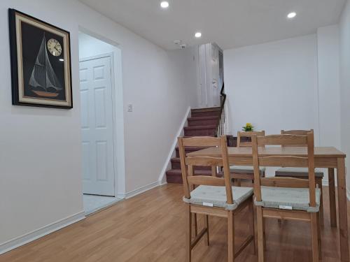 a dining room with a table and chairs at Lala-near Pearson airport-mall-free parking in Mississauga