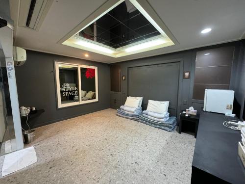 a room with two couches and a window in it at Songjeong Coco Hotel in Busan