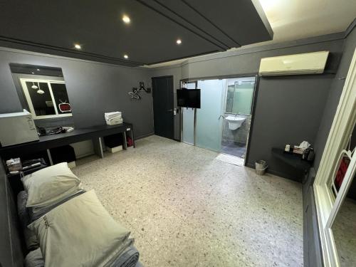 a room with a bed and a bathroom with a toilet at Songjeong Coco Hotel in Busan