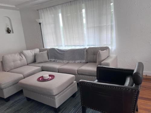 a living room with a couch and a chair at Charming 3 Bedroom Cottage Apartment in a Tudor-Style Home in Pittsburgh