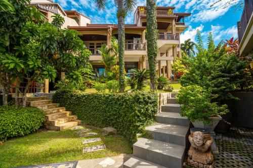a statue of a cat in front of a house at Ocean Pearl Seaview Residence in Rawai Beach
