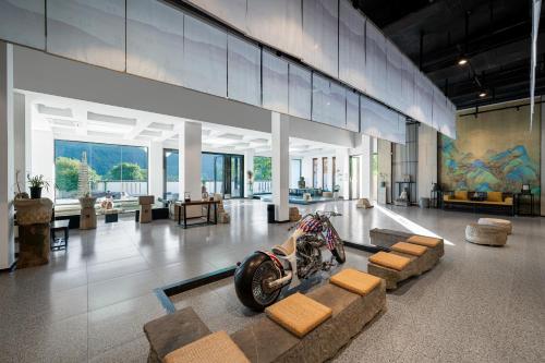 a museum with a motorcycle on display in a room at Yangshuo Mountain Vista Courtyard in Yangshuo